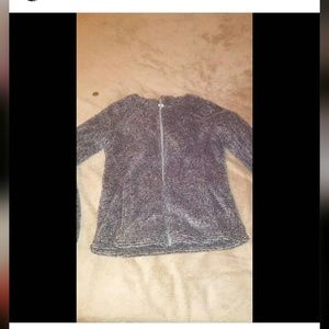 A fuzzy grey and black sweater